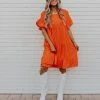 Adora THE OAKLEY TIERED BABYDOLL DRESS IN ORANGE DRESSES