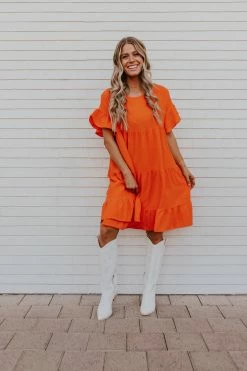 Adora THE OAKLEY TIERED BABYDOLL DRESS IN ORANGE DRESSES