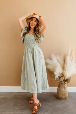 Miou Muse THE SAGE SMOCKED MIDI DRESS IN GREEN