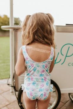 PINK DESERT GIRLS MINI RUFFLE LEG SCOOP ONE PIECE SWIMSUIT IN POPSICLE