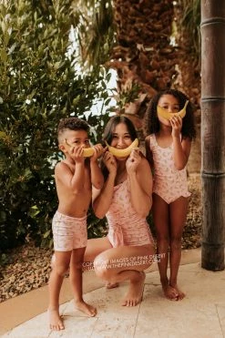 PINK DESERT GIRLS MINI RUFFLE LEG SCOOP ONE PIECE SWIMSUIT IN BUBBLEGUM BANANA