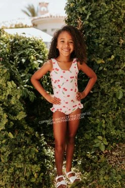 PINK DESERT GIRLS MINI RUFFLE LEG SCOOP ONE PIECE SWIMSUIT IN CHERRY BOMB