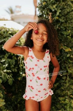 PINK DESERT GIRLS MINI RUFFLE LEG SCOOP ONE PIECE SWIMSUIT IN CHERRY BOMB