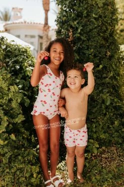 PINK DESERT GIRLS MINI RUFFLE LEG SCOOP ONE PIECE SWIMSUIT IN CHERRY BOMB