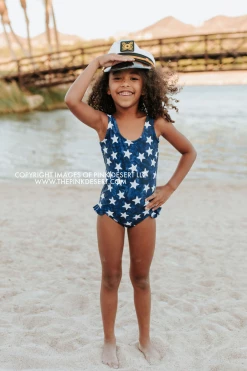 PINK DESERT GIRLS MINI RUFFLE LEG SCOOP ONE PIECE SWIMSUIT IN SPANGLED STAR PRINT