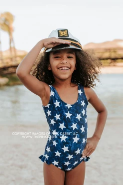 PINK DESERT GIRLS MINI RUFFLE LEG SCOOP ONE PIECE SWIMSUIT IN SPANGLED STAR PRINT