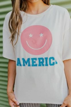 Style U THE AMERICA SMILEY GRAPHIC TEE IN SAND TOPS