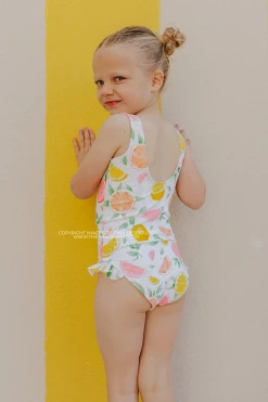 GIRLS MINI RUFFLE LEG SCOOP ONE PIECE SWIMSUIT IN CITRUS PRINT BY SASSY RED LIPSTICK X PINK DESERT