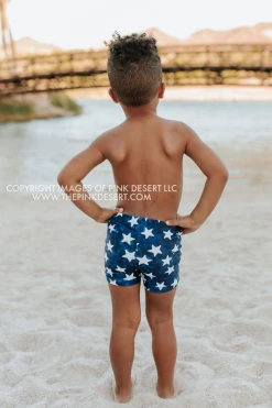 PINK DESERT BOYS EUROPEAN CUT SWIM SHORT IN SPANGLED STAR PRINT