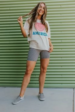 Style U THE AMERICA SMILEY GRAPHIC TEE IN SAND TOPS